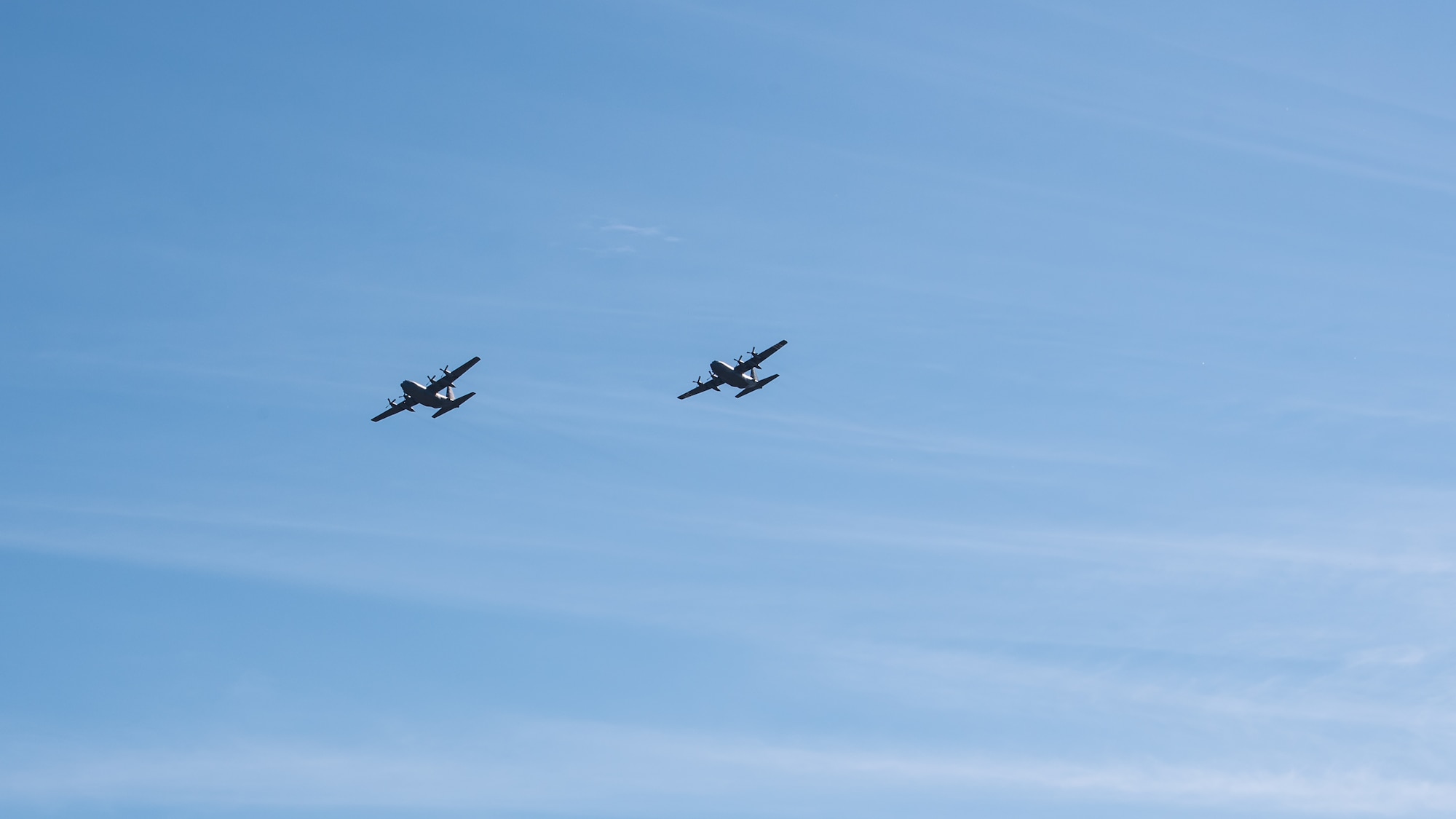 Two Kentucky Air National Guard C-130 Hercules aircraft from the 123rd Airlift Wing fly over Louisville, Ky., May 1, 2020, as part of Operation American Resolve, a nationwide salute to all those supporting COVID-19 response efforts. The operation is intended to lift morale during a time of severe health and economic impacts that have resulted from COVID-19. (U.S. Air National Guard photo by Senior Airman Chloe Ochs)