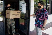 A U.S. Marine takes food to be delivered to first responders aboard Marine Corps Base Hawaii, May. 1, 2020. MCCS Hawaii and Rainbow Sales & Marketing donated food to first responders aboard MCBH to show support for their efforts and ease the burden placed on them and their families supporting the MCBH community.  (U.S. Marine Corps photo by Sgt. Alex Kouns)