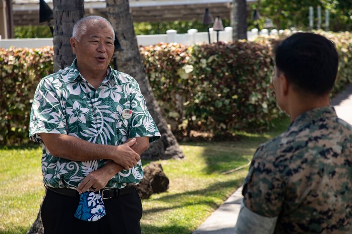 U.S. Marine Corps Col. Raul Lianez, commanding officer, Marine Corps Base Hawaii, speaks to John Nishida, Director of Business Operations, Marine Corps Community Services Hawaii, outside of Kahuna's Sports Bar & Grill aboard the base, May. 1, 2020. MCCS Hawaii and Rainbow Sales & Marketing donated food to first responders aboard MCBH to show support for their efforts and ease the burden placed on them and their families supporting the MCBH community.  (U.S. Marine Corps photo by Sgt. Alex Kouns)