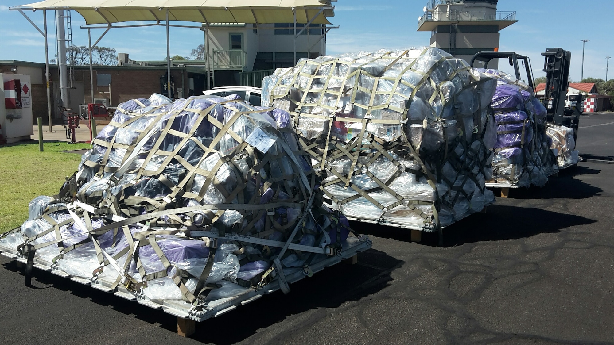 Palletized mail is unloaded off of a C-17 Globemaster III in Alice Springs, Australia, April 28, 2020. The Pacific Air Forces Air Postal Squadron partnered with the U.S. Army, U.S. Air Force Air Mobility Command as well as the U.S. Navy to deliver thousands of pounds of mail to Republic of Korea, Japan, and Australia. (Courtesy Photo)