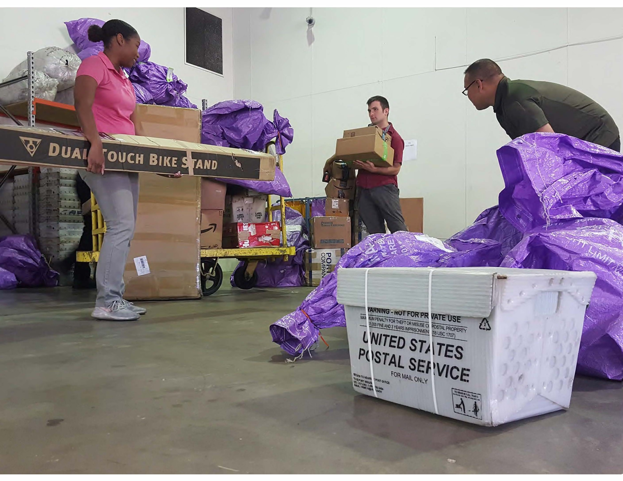 Airmen assigned to the Pacific Air Forces Air Postal Squadron prepare mail for delivery at the Sydney Aerial Mail Terminal in Sydney, Australia, April 28, 2020. The Pacific Air Forces Air Postal Squadron partnered with the U.S. Army, U.S. Air Force Air Mobility Command as well as the U.S. Navy to deliver thousands of pounds of mail to Republic of Korea, Japan, and Australia. (Courtesy Photo)