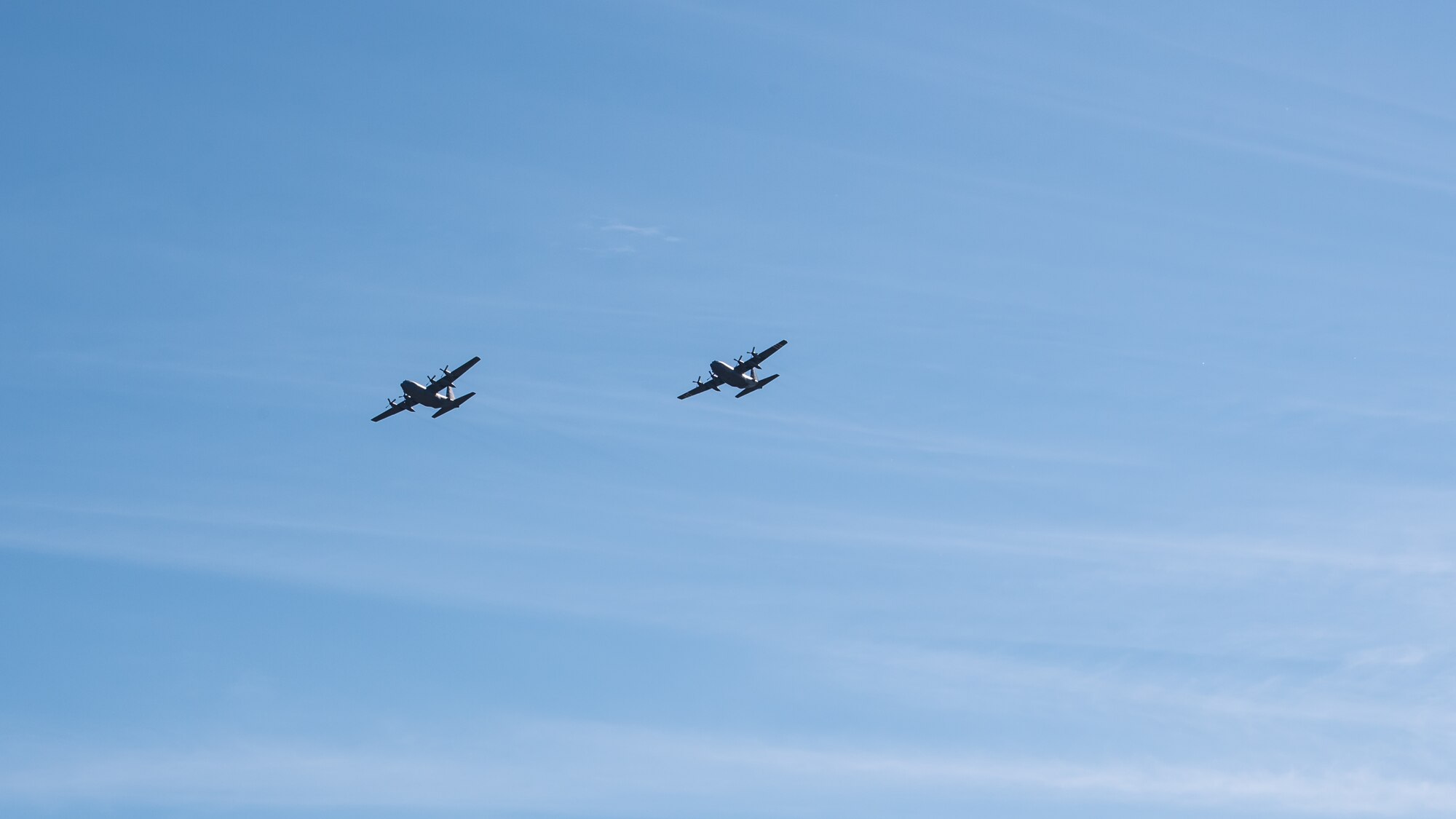 Two Kentucky Air National Guard C-130 Hercules aircraft from the 123rd Airlift Wing fly over Louisville, Ky., May 1, 2020, as part of Operation American Resolve, a nationwide salute to all those supporting COVID-19 response efforts. The operation is intended to lift morale during a time of severe health and economic impacts that have resulted from COVID-19. (U.S. Air National Guard photo by Senior Airman Chloe Ochs)