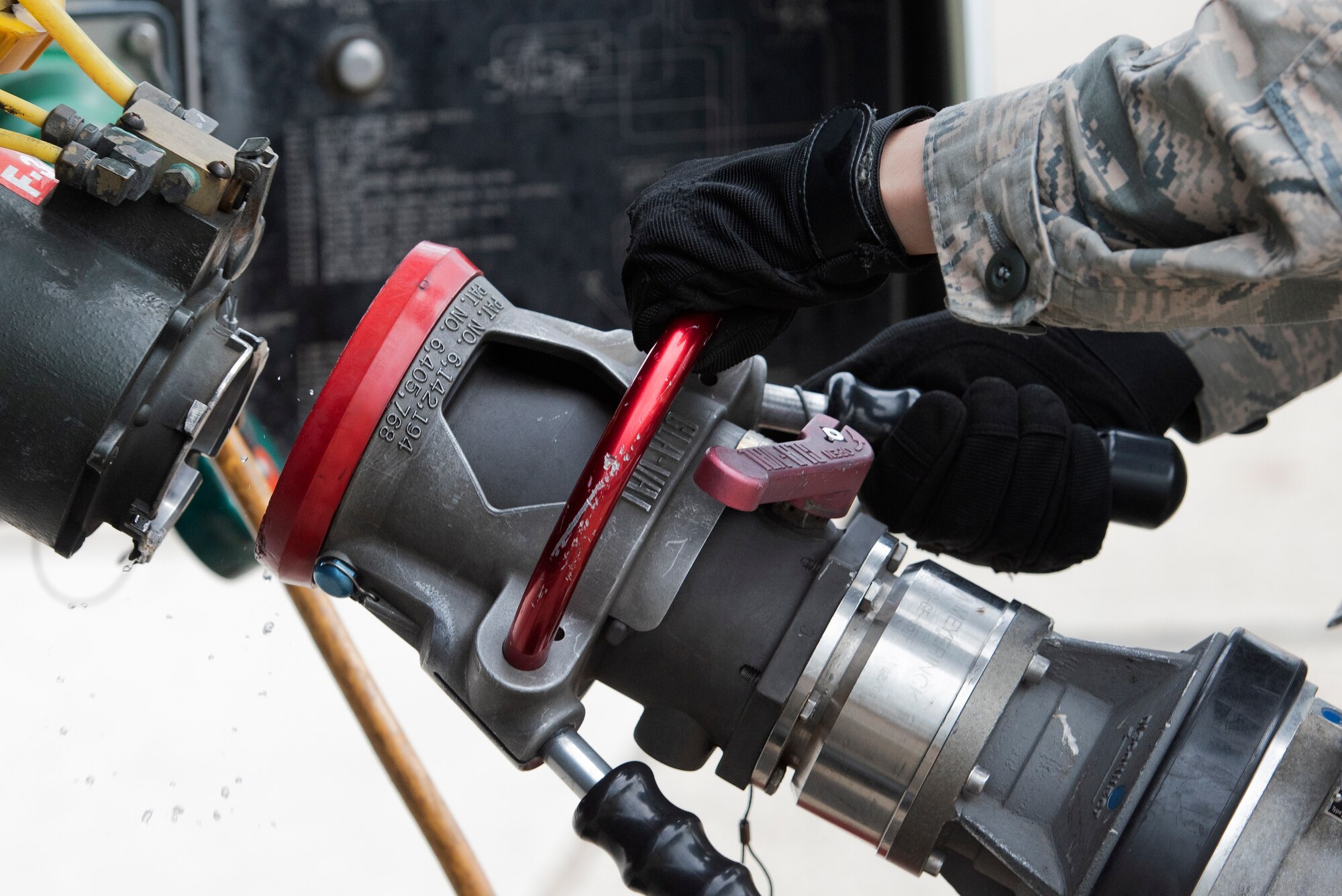Airman 1st Class Issac Ellis, a 48th Logistics Readiness Squadron fuels mobile distribution operator, hooks up the fillstand pantograph to the bottom loader of an R-11 refueling truck at Royal Air Force Lakenheath, England, April 30, 2020. Despite COVID-19, 48th LRS Airmen continue to execute their mission of handling the storage and delivery of gasoline, diesel, jet fuel, cryogenic liquids and other materials required to project airpower. (U.S. Air Force photo by Airman 1st Class Jessi Monte)