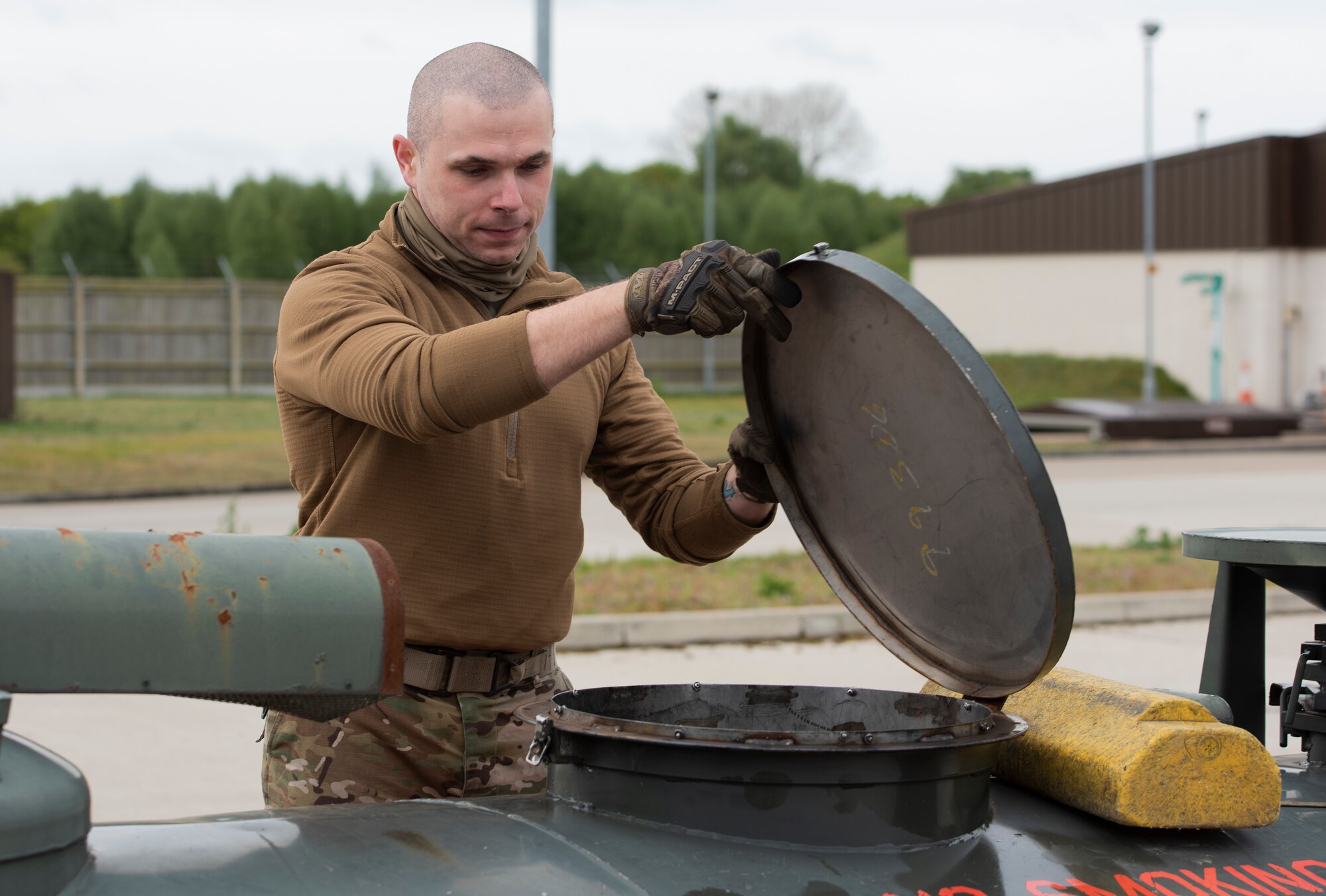 Staff Sgt. Erik Brooks, 48th Logistics Readiness Squadron fuels preventative maintenance noncommissioned officer in charge, closes the lid on a 400-gallon fuel reclamation bowser at Royal Air Force Lakenheath, England, April 30, 2020. Despite COVID-19, 48th LRS Airmen continue to execute their mission of handling the storage and delivery of gasoline, diesel, jet fuel, cryogenic liquids and other materials required to project airpower. (U.S. Air Force photo by Airman 1st Class Jessi Monte)