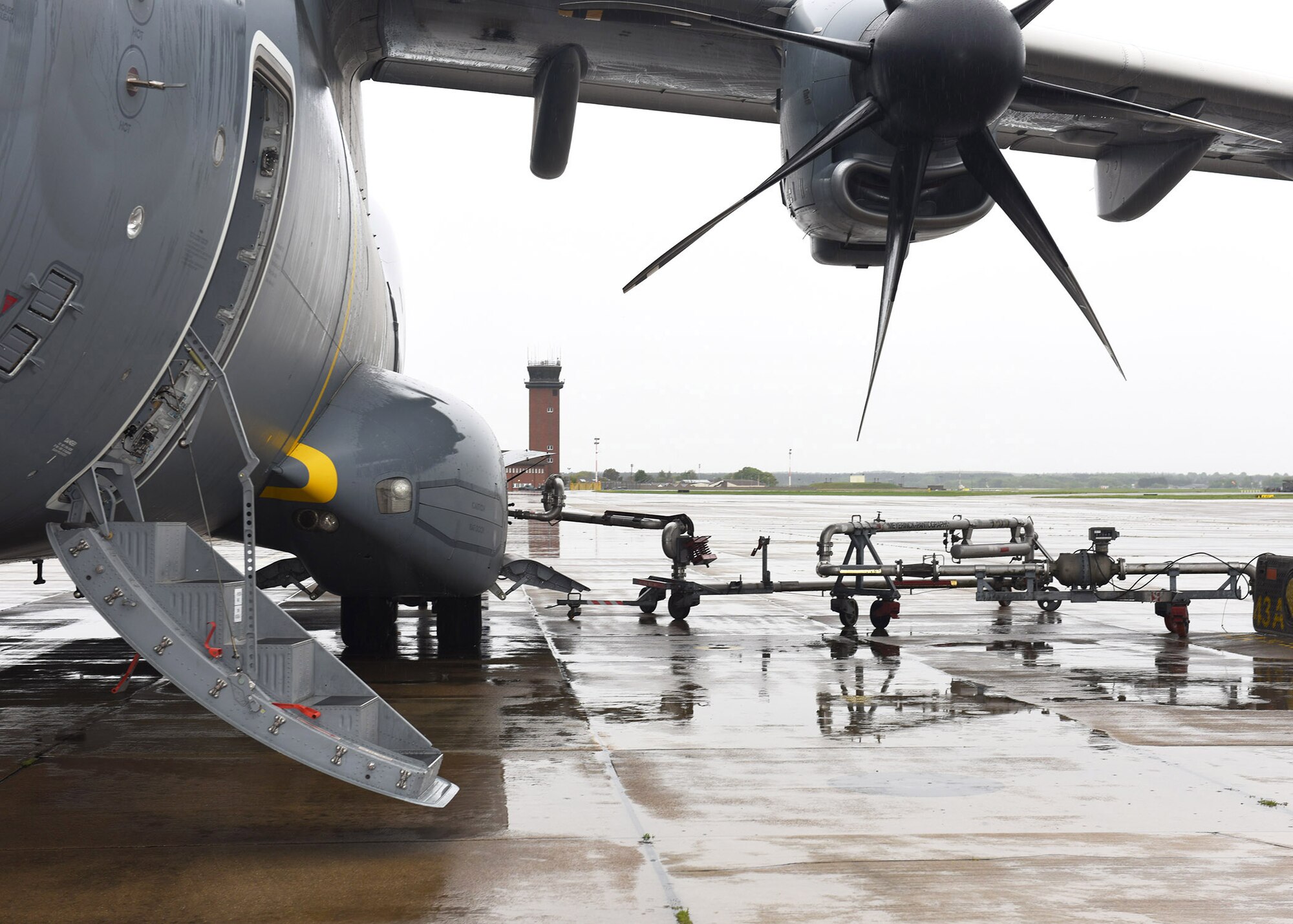 An aviation fueling system is connected to a fuel line as a Turkish Airbus A400M Atlas is refueled at RAF Mildenhall, England, April 28, 2020. Turkish air force members stopped on their way to deliver COVID-19 medical supplies to Joint Base Andrews, Md. Airmen from RAF Mildenhall were ready and waiting to assist the crew and refuel the aircraft, demonstrating our mutual support of NATO allies during this difficult time. (U.S. Air Force photo by Karen Abeyasekere)