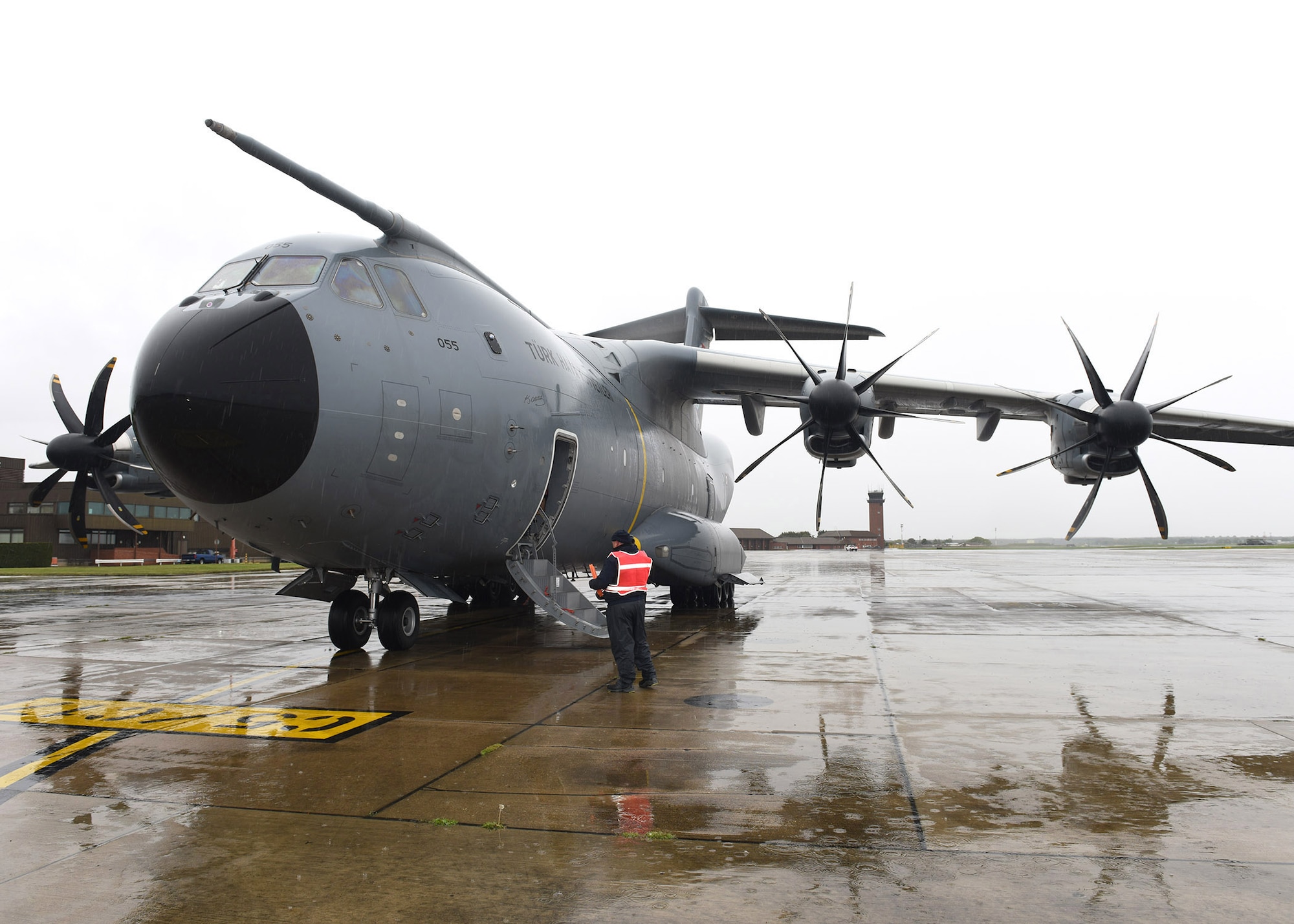 A contractor from the 100th Maintenance Squadron waits for the crew of a Turkish Airbus A400M Atlas to disembark April 28, 2020, at RAF Mildenhall, England. The crew delivered COVID-19 medical provisions including masks, medical gloves and protective goggles, to support the US during this difficult time. (U.S. Air Force photo by Karen Abeyasekere)
