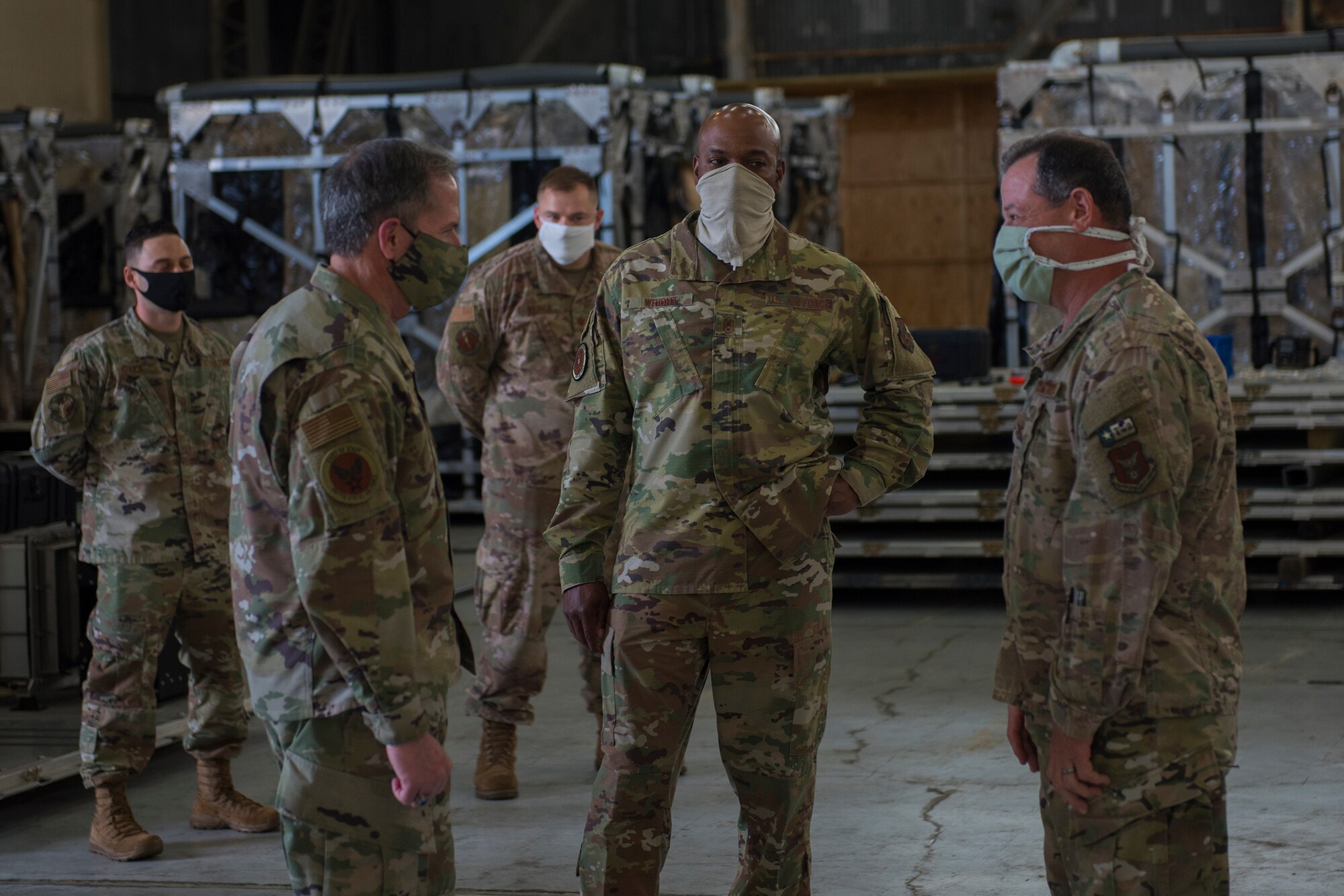 Chief of Staff of the Air Force Gen. David L. Goldfein, left, and Chief Master Sgt. of the Air Force Kaleth O. Wright, center, discuss the Transport Isolation System with Col. Adam Willis, 315th Airlift Wing Commander, right, at Joint Base Charleston, S.C., April 30, 2020. Goldfein and Wright were at JB Charleston to observe current aeromedical evacuation TIS operations and Palmetto Spark, JB Charleston’s innovation cell. The TIS is a system designed to safely transport infectious patients by aircraft and is being used as part of the Department of Defense’s COVID-19 response. Palmetto Spark allows Airmen to get help with coming up with innovative ideas for their squadron and has been making protective gear for non-medical personnel and hand sanitizer for units across JB Charleston. (U.S. Air Force photo by Airman Sara Jenkins)