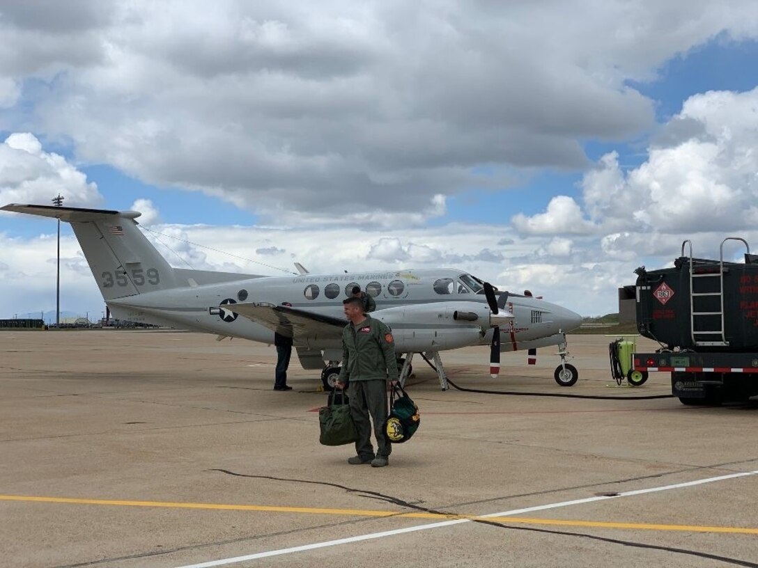 514th Flight Test Squadron Commander Lt. Col. Nathan Litz walking toward a C-12 aircraft.