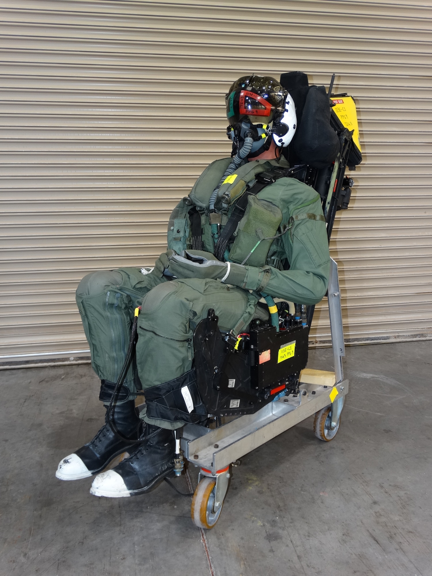 A manikin is integrated with the ejection seat for an F-35 canopy test March 26, 2020, at Holloman Air Force Base, N.M. The build-up, completed by the 846th Test Squadron of the 704th Test Group, Arnold Engineering Development Complex, involved installing the ejection seat explosives and dressing of the manikin prior to installation in the aircraft forebody test apparatus. (U.S. Air Force photo by Lt. Col. Gregory Barber)