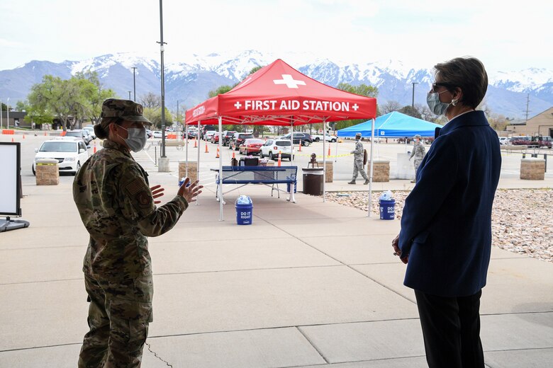 Secretary of the Air Force Barbara Barrett speaks with Maj. Emily Dietrich, 75th Medical Group, near a first aid station tent.