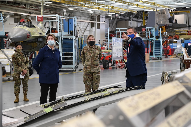 Secretary of the Air Force Barbara Barrett is briefed by Braeden Stander, 573rd Aircraft Maintenance Squadro, inside a depot maintenance hangar.