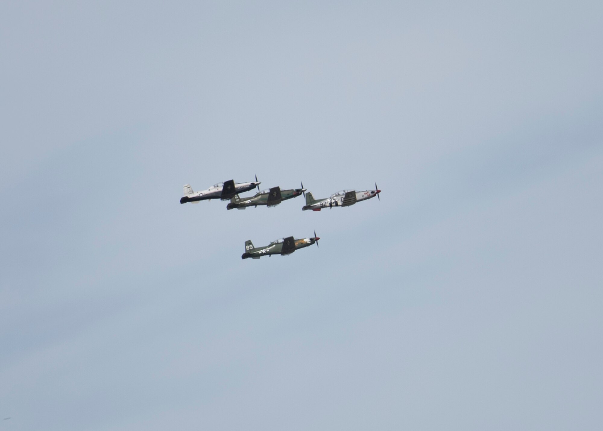 Four T-6 Texan II aircraft participate in the Spirit of Texoma flyover on May 1, 2020. The flyover was a way for Sheppard Air Force Base, Texas, to show gratitude towards the COVID-19 frontline healthcare workers in the local community. The flyover consisted of a 4-ship T-38 Talon formation and a 4-ship T-6 Texan II formation, with a T-38 and T-6 chase plane behind them for photo and video. (U. S. Air Force photo by Senior Airman Pedro Tenorio)