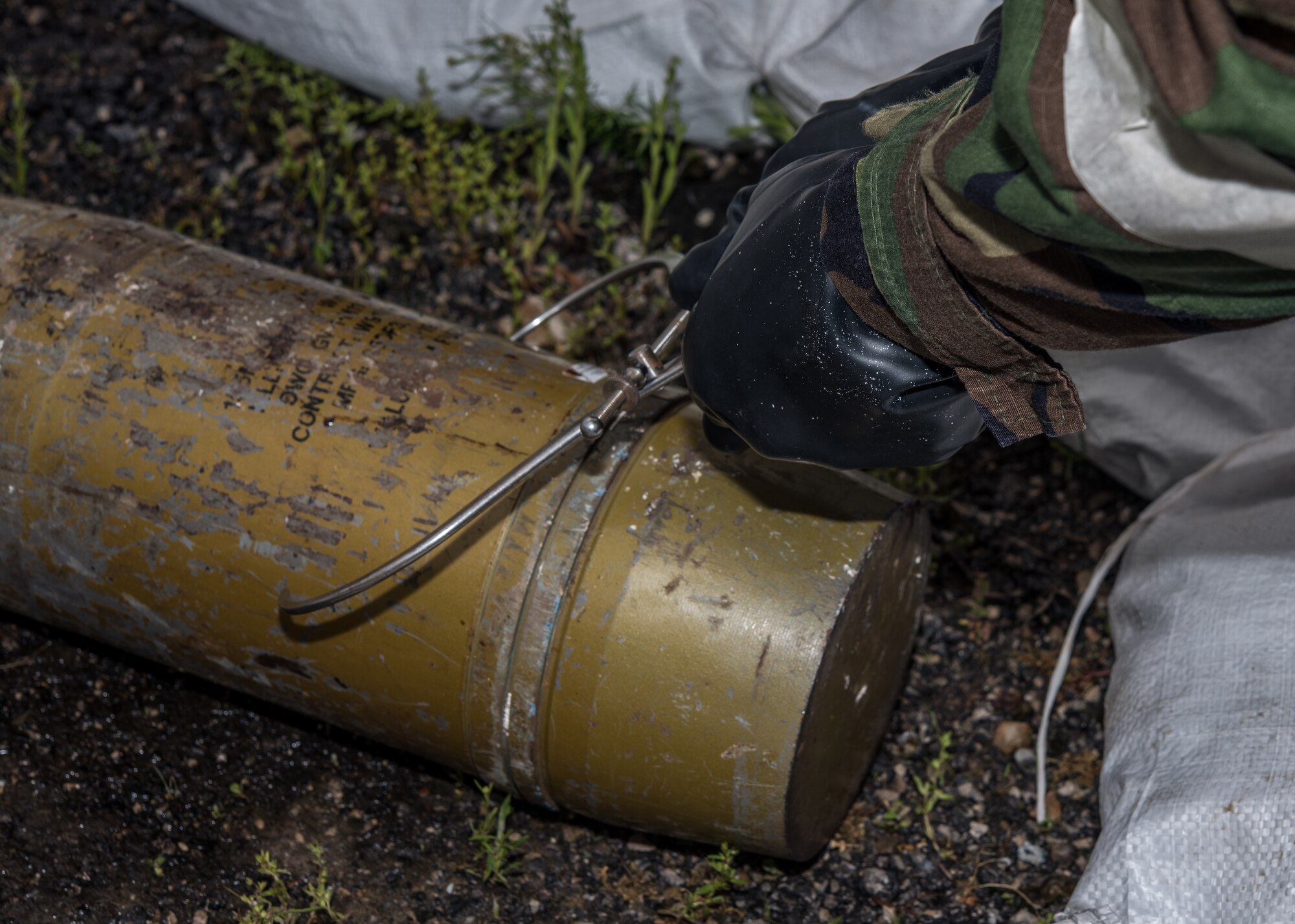 A 509th Civil Engineer Squadron Explosive Ordnance Disposal technician measures a simulated chemical ordnance during training at Whiteman Air Force Base, Missouri, April 30, 2020.