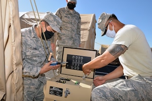 Reserve Citizen Airman Tech. Sgt. Shelby King, 507th Civil Engineer Squadron electrical systems NCO in charge (center), leads and mentors fellow Air Force Reserve electrical systems journeymen Senior Airman Steban Tijerina, 433rd CES, and Air National Guardsman Staff Sgt. Lawrence Ramirez, 149th CES, as they troubleshoot a power distribution panel for an environmental control unit April 30, 2020 at Joint Base San Antonio-Lackland, Texas.
