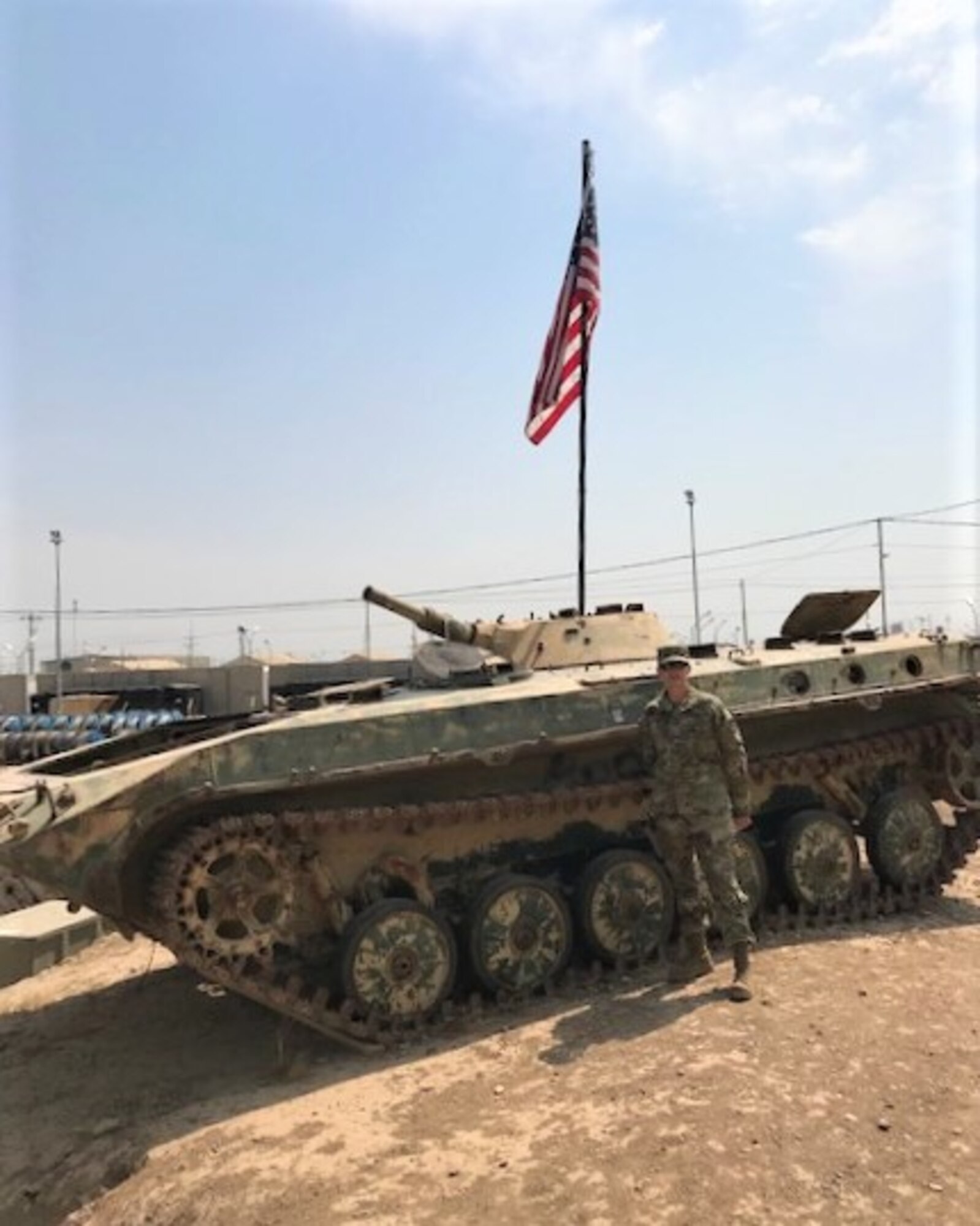 Senior Master Sgt. Joy Rohauer poses next to a tank at one of the bases she visited as the Air Force Central Command’s occupational safety superintendent, August 2019. During her site visits to bases in the area of operations, she evaluated the health and safety programs of the fighting force. (Courtesy photo)