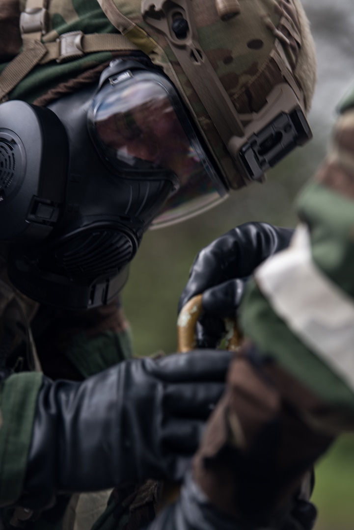 Senior Airman Dawson Hindman, 509th Civil Engineer Squadron Explosive Ordnance Disposal technician, applies tape on a simulated chemical ordnance during training at Whiteman Air Force Base, Missouri, April 30, 2020. Despite operational changes from the COVID-19 response, the EOD team remains mission capable and ready to serve the Midwestern United States.   (U.S. Air Force photo by Senior Airman Thomas Barley)