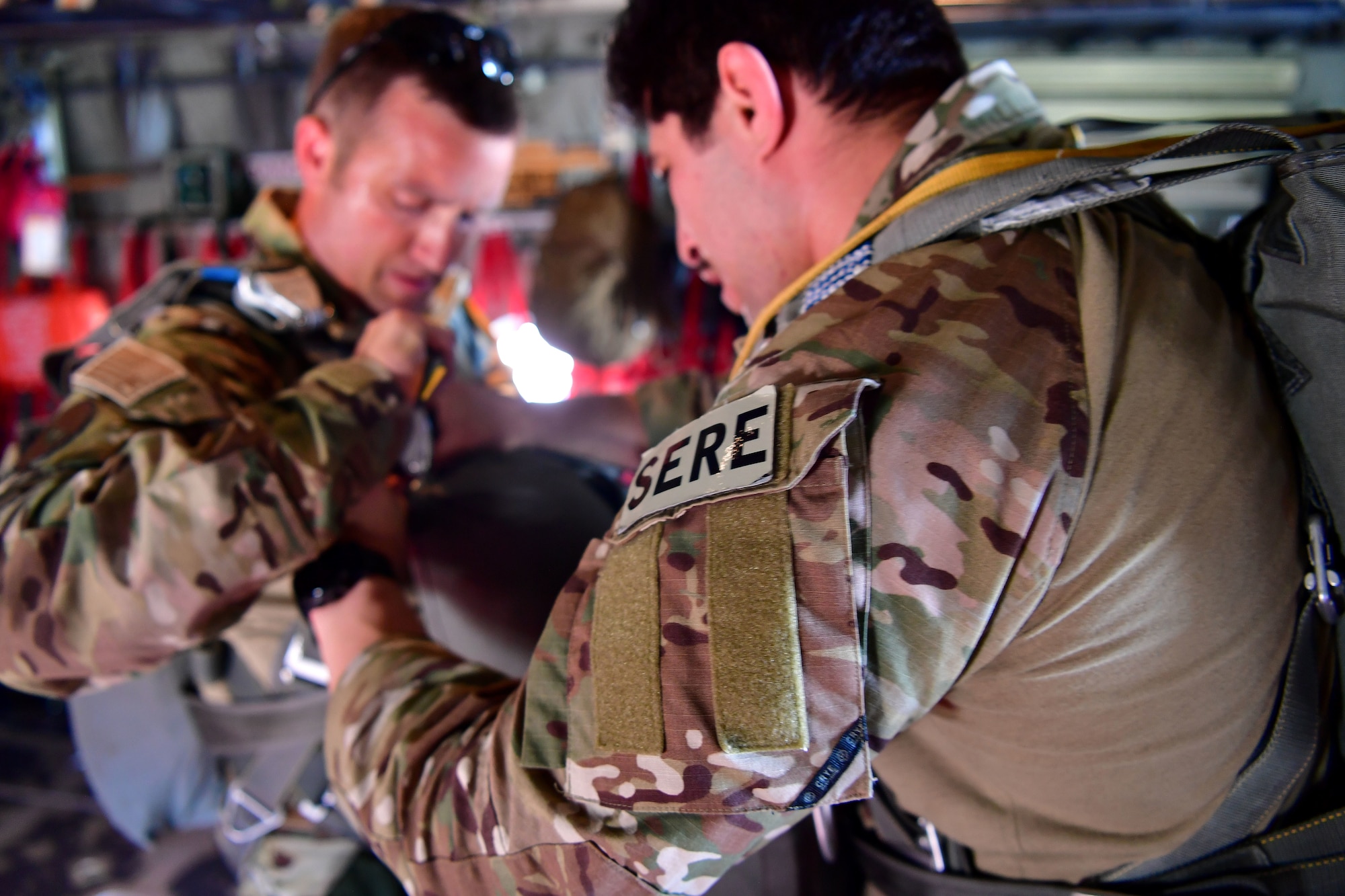 Tech. Sgt. Nader Maghribi, 19th Operations Support Squadron Survival Evasion Resistance and Escape specialist, performs an equipment check on U.S. Air Force Master Sgt. Ed Dawejko, 19th OSS SERE specialist, in Florida.