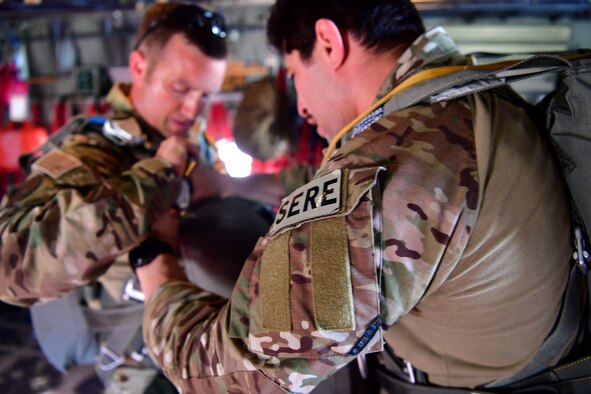 Tech. Sgt. Nader Maghribi, 19th Operations Support Squadron Survival Evasion Resistance and Escape specialist, performs an equipment check on U.S. Air Force Master Sgt. Ed Dawejko, 19th OSS SERE specialist, in Florida.