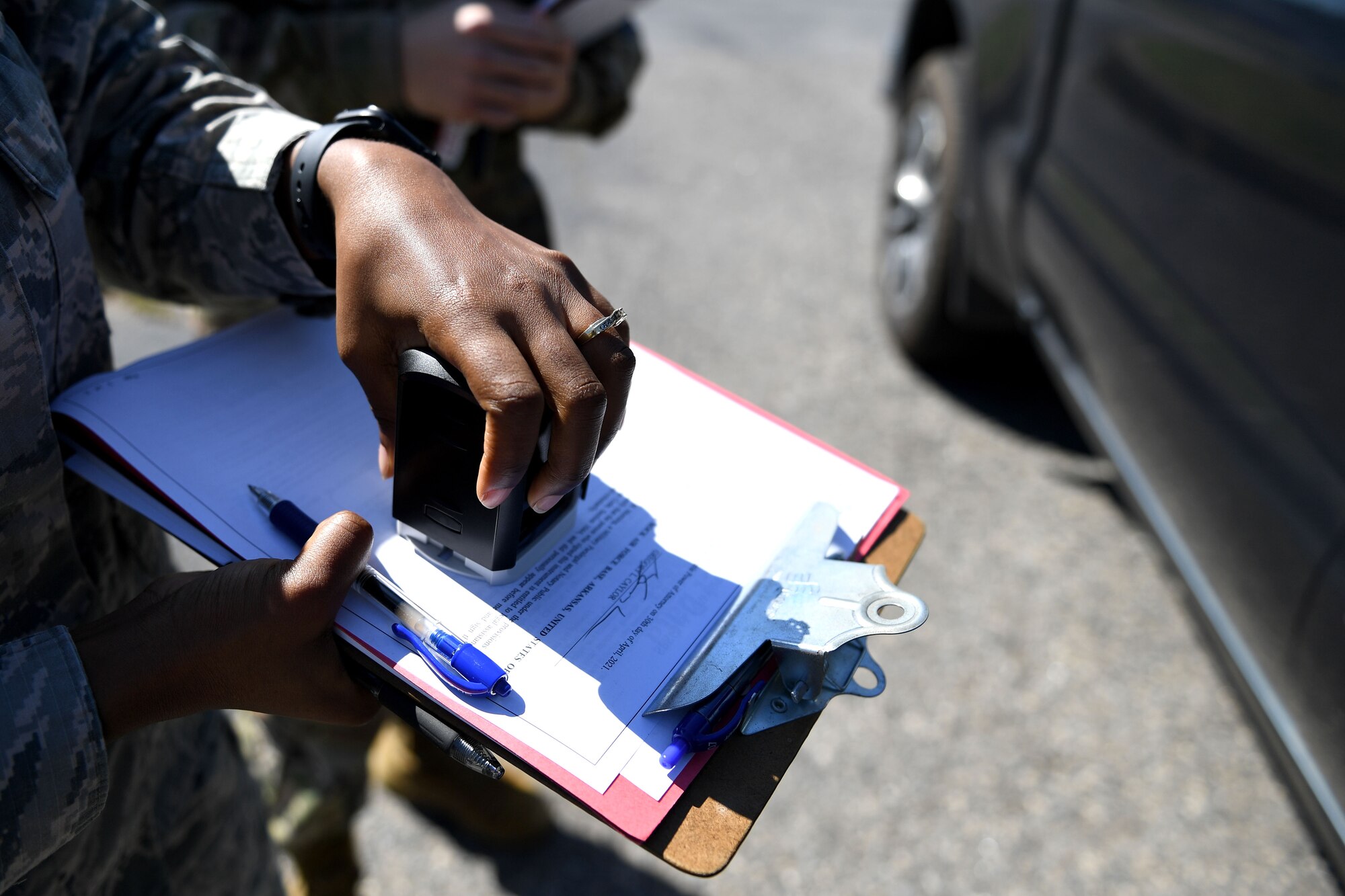A woman stamps a paper.