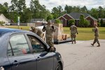 North Carolina National Guard Soldiers assigned to 2-130 Airfield Operations Battalion, 449th Theater Aviation Brigade, load boxes of food into vehicles while helping  Action Pathways Second Harvest Food Bank of Southeast North Carolina distribute food in Raeford, N.C. on May 5, 2020.