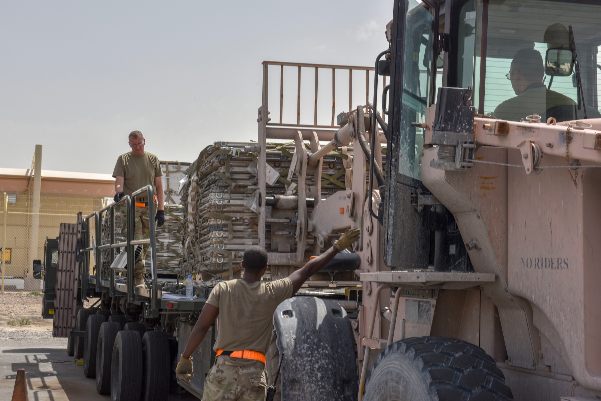 Airmen with the 8th Expeditionary Air Mobility Squadron move cargo on the flightline at Al Udeid Air Base, Qatar on April 28, 2020. The 8 EAMS Airmen support dozens of missions per day, often moving hundreds of thousands of pounds of cargo and service members around the U.S. Air Forces Central Command area of responsibility. (U.S. Air Force photo by Tech. Sgt. John Wilkes)