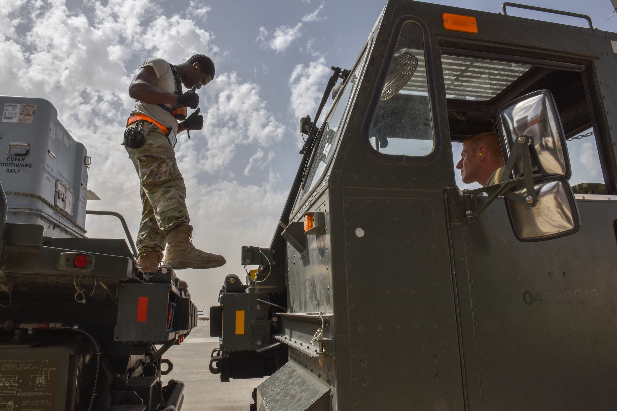 Airmen with the 8th Expeditionary Air Mobility Squadron move cargo on the flightline at Al Udeid Air Base, Qatar on April 28, 2020. The 8 EAMS Airmen support dozens of missions per day, often moving hundreds of thousands of pounds of cargo and service members around the U.S. Air Forces Central Command area of responsibility. (U.S. Air Force photo by Tech. Sgt. John Wilkes)