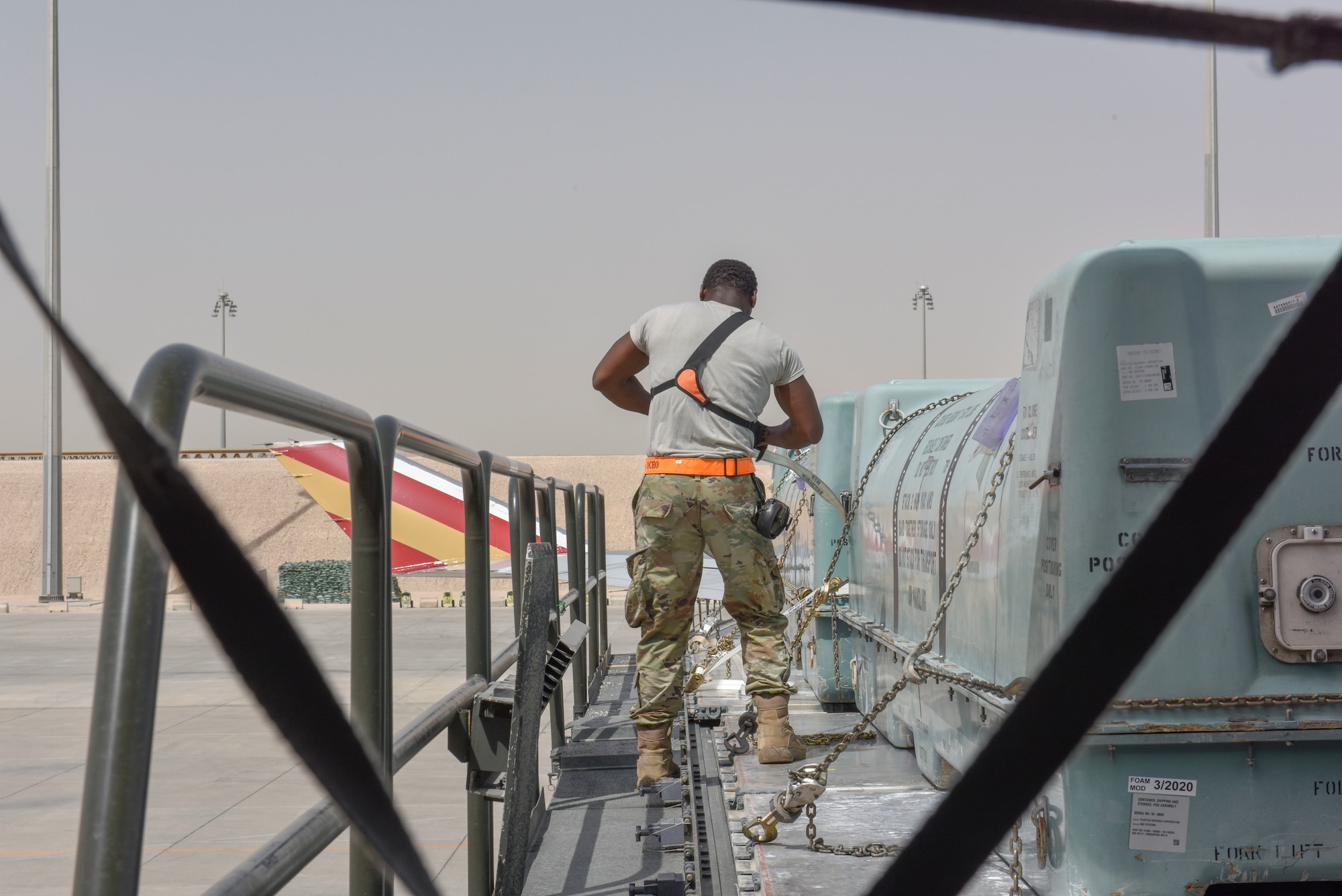 Airmen with the 8th Expeditionary Air Mobility Squadron move cargo on the flightline at Al Udeid Air Base, Qatar on April 28, 2020. The 8 EAMS Airmen support dozens of missions per day, often moving hundreds of thousands of pounds of cargo and service members around the U.S. Air Forces Central Command area of responsibility. (U.S. Air Force photo by Tech. Sgt. John Wilkes)