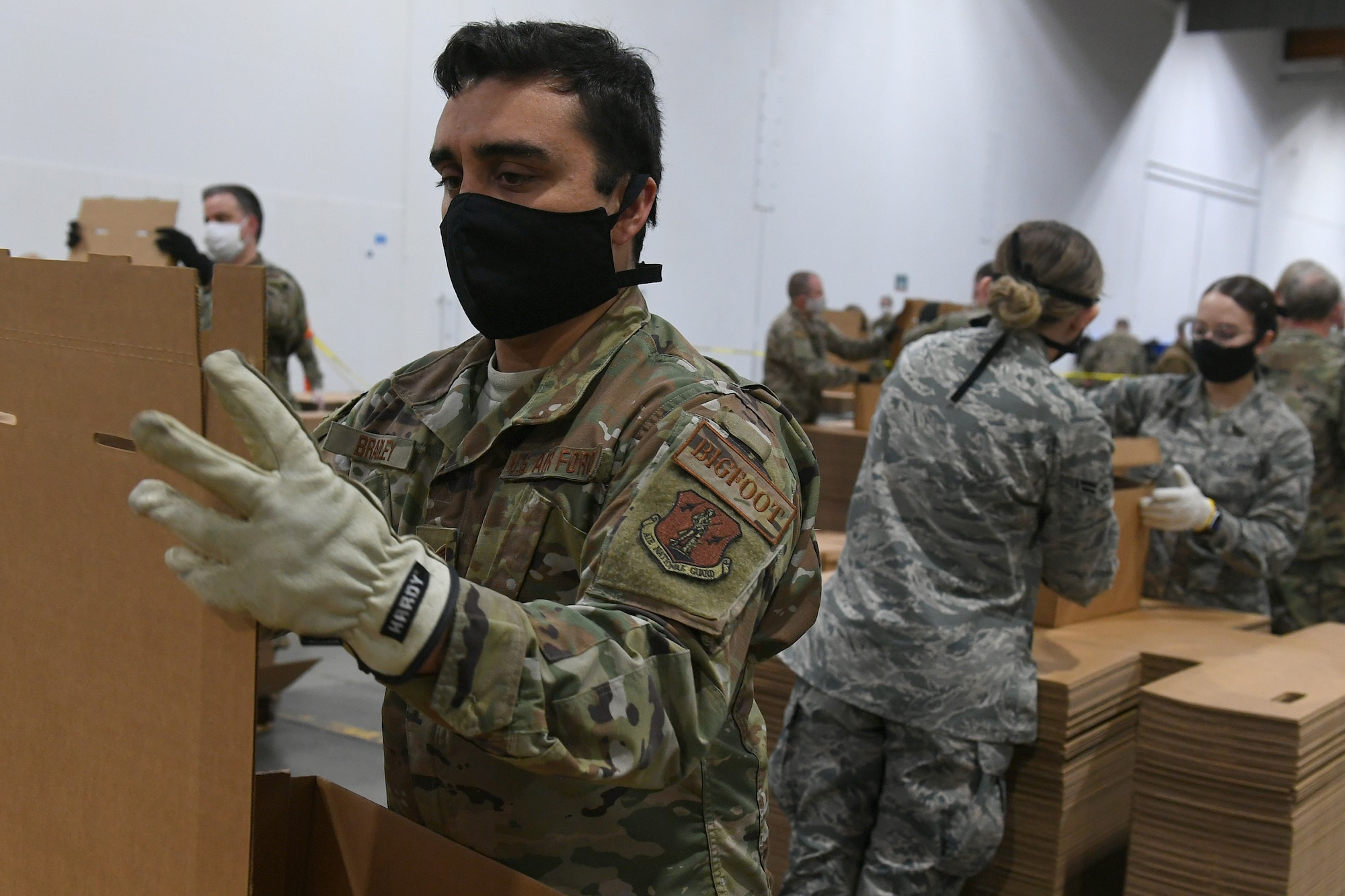 U.S. Air Force Staff Sgt. Matthew Bradley, assigned to the 225th Air Defense Squadron, prepares food boxes at the Food Lifeline COVID Response warehouse April 23, 2020, in Seattle, Washington.  More than 250 Air and National Guardsmen are assigned to the warehouse where they are able to prepare, on average, 268 boxes an hour per line. (U.S. Air National Guard photo by Master Sgt. Tim Chacon)