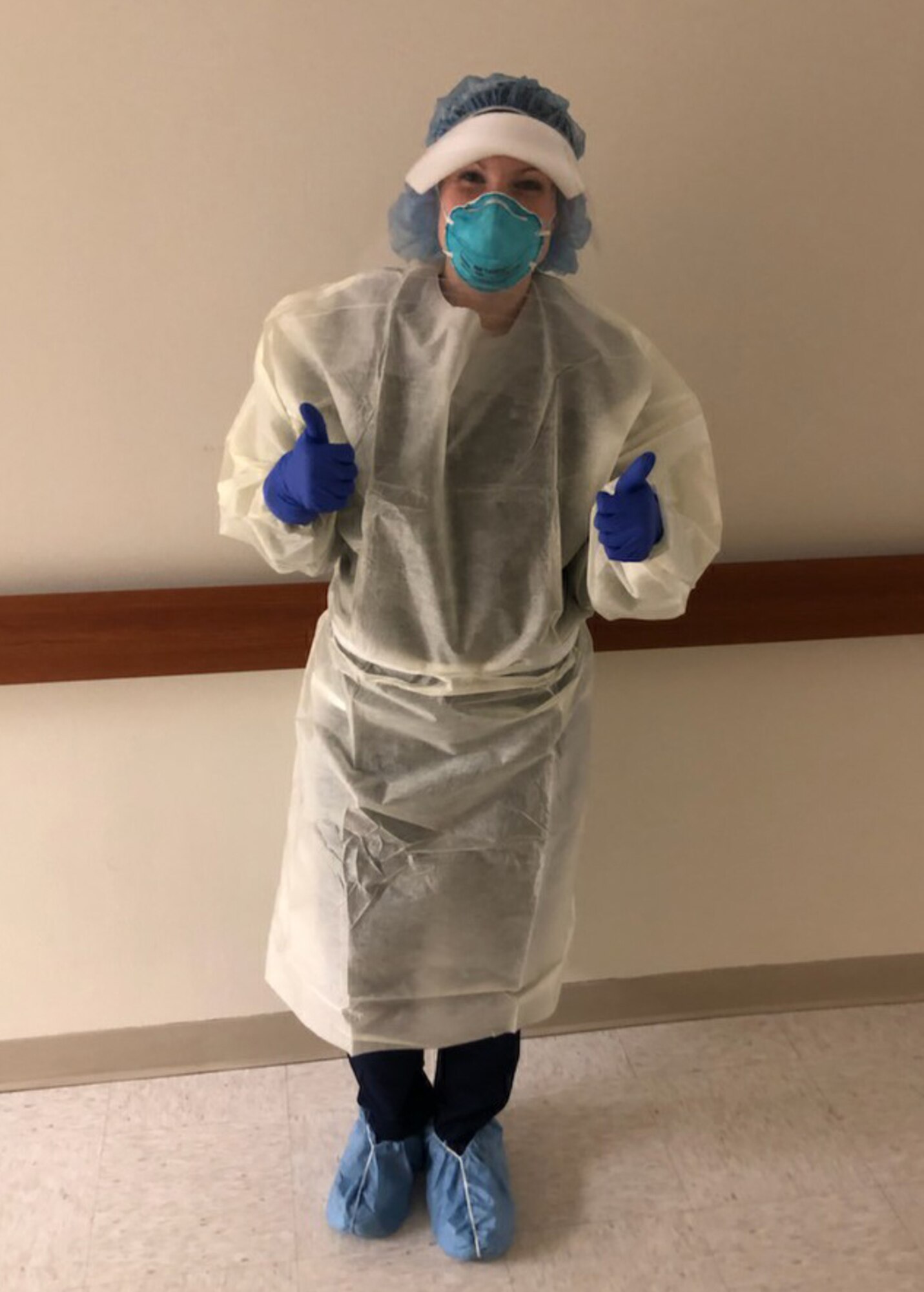 Danielle Allaire, a travel nurse in her civlian life, dresses for patient care before entering the room of a COVID-19 patient. Allaire is a master sergeant in the 403rd Aerial Port Squadron as a air transportation specialist and passenger serviices noncommissioned officer in charge. (courtesy photo)