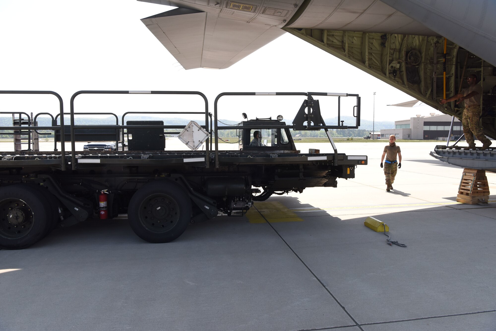 U.S. Airmen assigned to the 721st Aerial Port Squadron finalize a cargo upload onto a C-130J Super Hercules