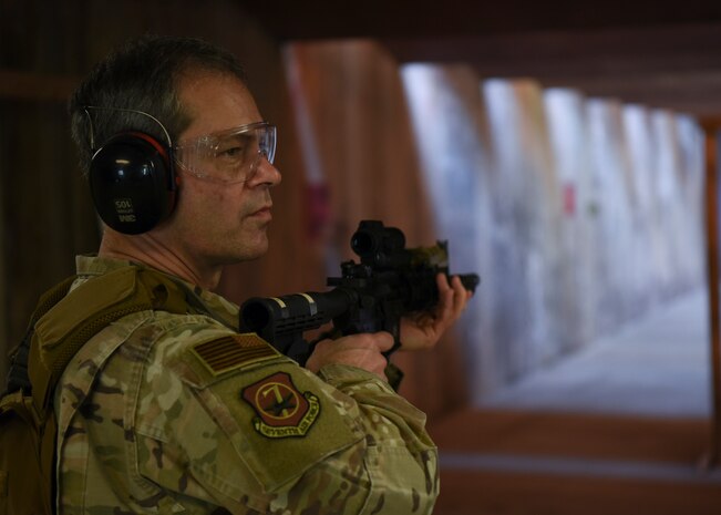 U.S. Air Force Lt. Gen. Ken Wilsbach, 7th Air Force commander, listens to an 8th Security Forces Squadron Combat Arms and Training and Maintenance instructor prior to weapons training at Kunsan Air Base, Republic of Korea, May 1, 2020. Wilsbach also fired the M18 SIG Sauer Modular Handgun System during his visit. (U.S. Air Force photo by Staff Sgt. Anthony Hetlage)