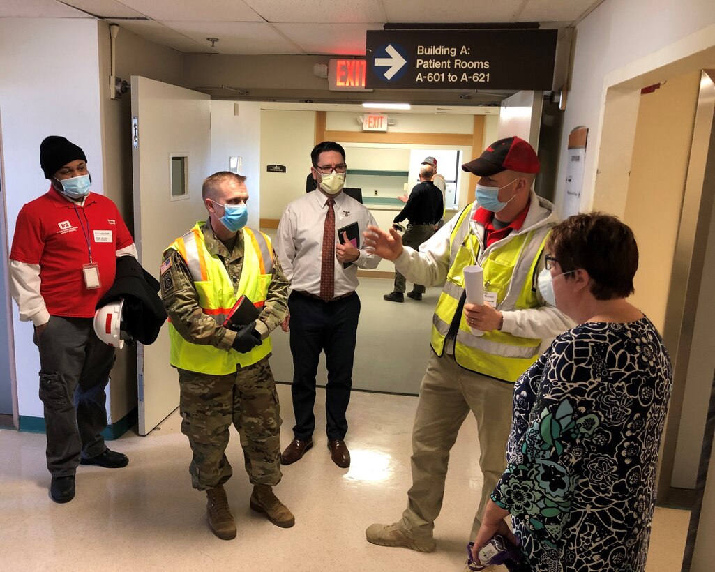 USACE Philadelphia District Deputy Commander LTC Brian Corbin (center) tours the recently completed St. Francis Medical Center Alternate Care Facility in Trenton, N.J. with USACE Engineer Derek Burleigh (second from right); Jamaal Edwards (left) of the USACE Philadelphia District Contracting Division and NJ Department of Health and hospital staff. The mission was part of a federal, state, and local response to the COVID-19 Pandemic.