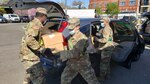 New York Army National Guard Soldiers, from left, Spc. Davier Weste, Spc. Cody Roche and Staff Sgt. Andre Hayden, assigned to the 1st Battalion, 258th Field Artillery, part of the 27th Infantry Brigade Combat Team, load cars with meals at the Queens Food Distribution Site May 2, 2020. The meals will be delivered to people who are quarantined and unable to go shopping.