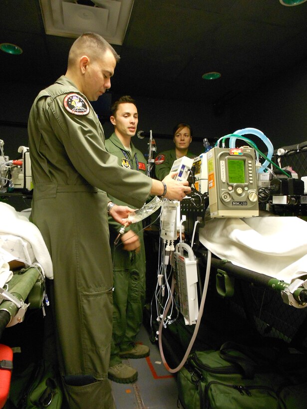 Air Force Cardiopulmonary Lab staff and CSTARS Cadre from the United States Air Force School of Aerospace Medicine (USAFSAM), at Wright-Patterson Air Force Base, including Chief Master Sgt. James Woods (forefront), Master Sgt. Jensen DeNijs (middle), and Master Sgt. Erin Seley (background) are shown evaluating a patient simulation scenario which incorporates the use of the 731 EMV+ ventilator used in their trial at the University of Cincinnati Medical Center C-STARS (Center for Sustainment of Trauma and Readiness Skills) in this July 2016 photo. C-STARS is a joint program between the University of Cincinnati Medical Center and the Air Force, offering training for military medical personnel in the areas of trauma and critical care. (U.S. Air Force photo/Dario Rodriquez)
