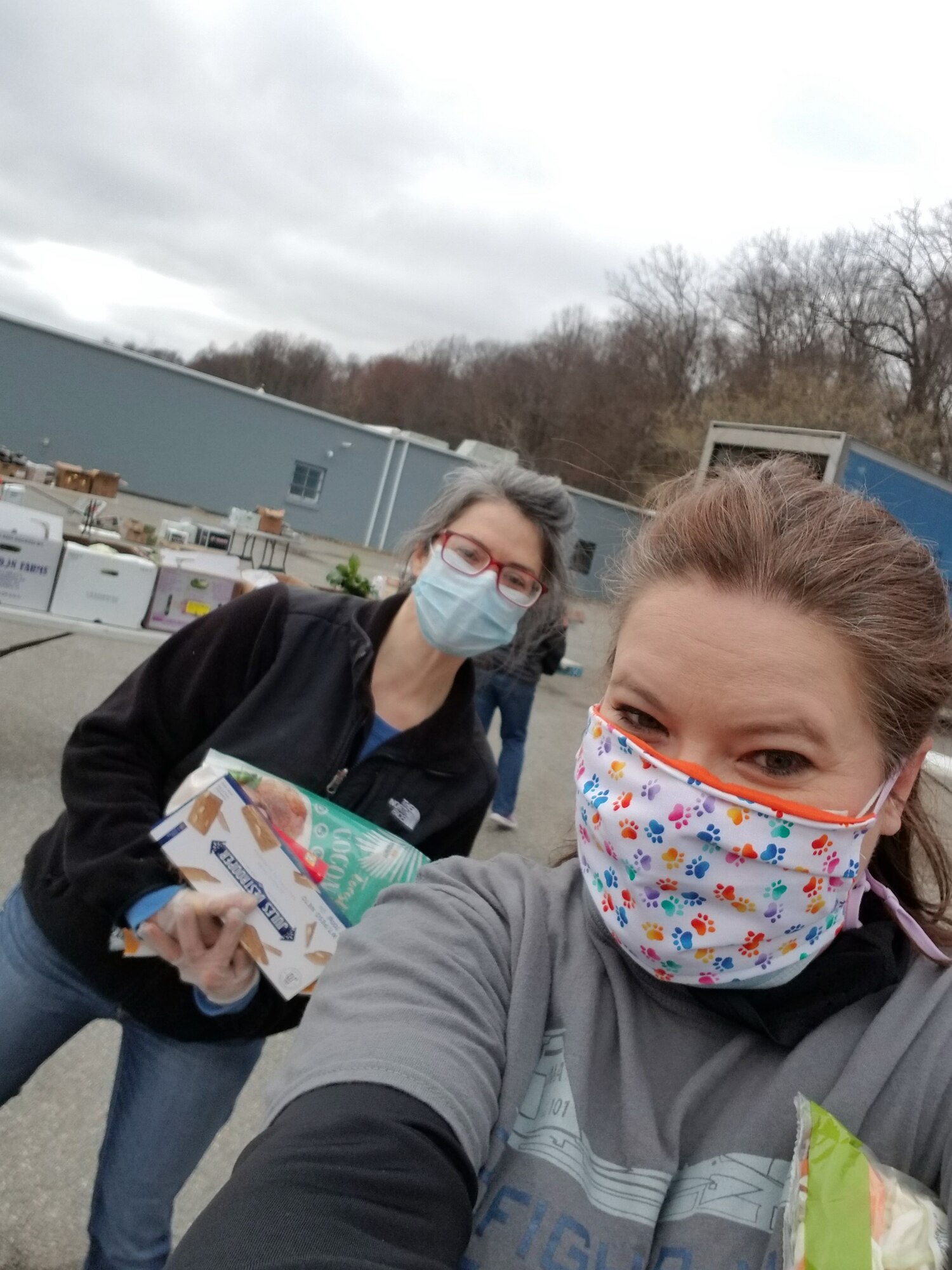 Lisa Potito, wellness team coordinator, right, and Mary Keeler, sexual assault response coordinator, left, help distribute food at a local nonprofit organization farmers market free for the military, April 4, 2020. (Courtesy photo)
