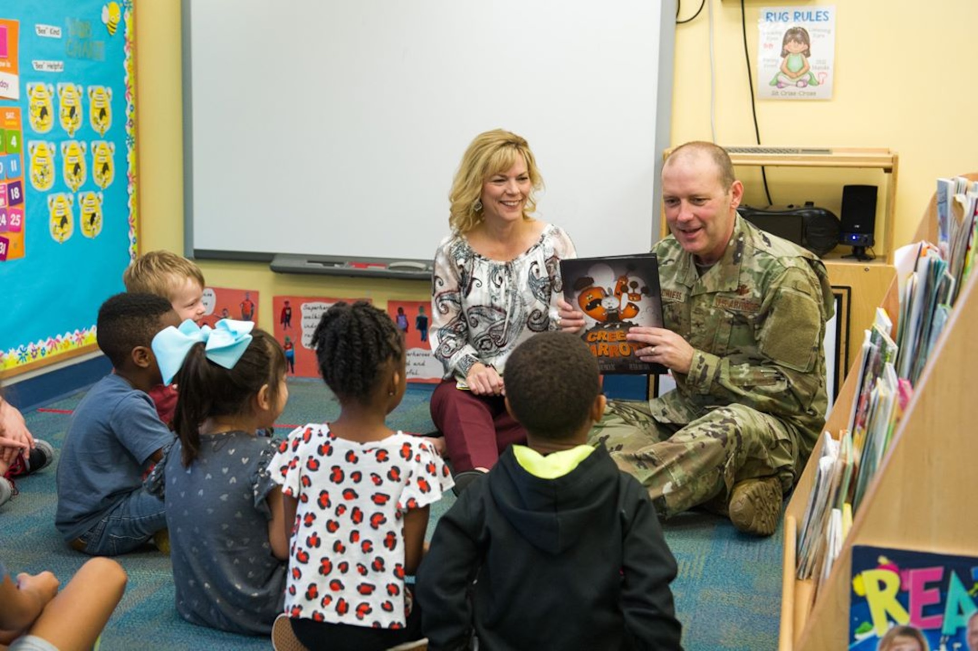 Brig. Gen. Doug Schiess, 45th Space Wing commander, and Mrs. Debbie Schiess, Key Spouse mentor, read to children to support literacy in January of 2020. Many online sources are available to continue our child's learning during the COVID-19 pandemic, such as the 45th SW School Liaison Office. (U.S. Air Force photo by Joshua Conti)