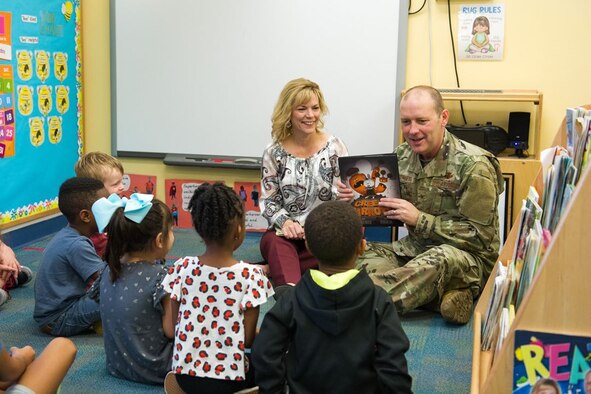 Brig. Gen. Doug Schiess, 45th Space Wing commander, and Mrs. Debbie Schiess, Key Spouse mentor, read to children to support literacy in January of 2020. Many online sources are available to continue our child's learning during the COVID-19 pandemic, such as the 45th SW School Liaison Office. (U.S. Air Force photo by Joshua Conti)