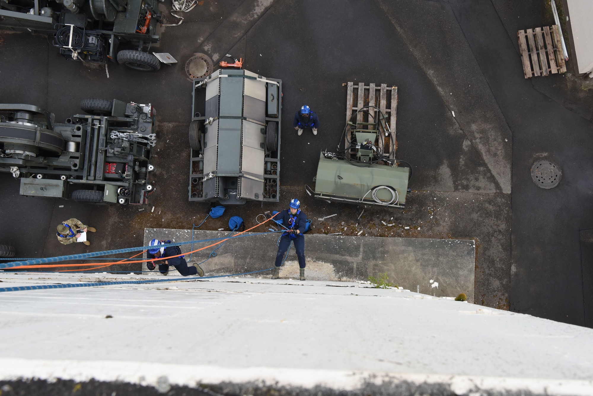 U.S. Air Force Airmen assigned to 86th Civil Engineer Squadron fire department rappel down a structure during a rescue certification course.