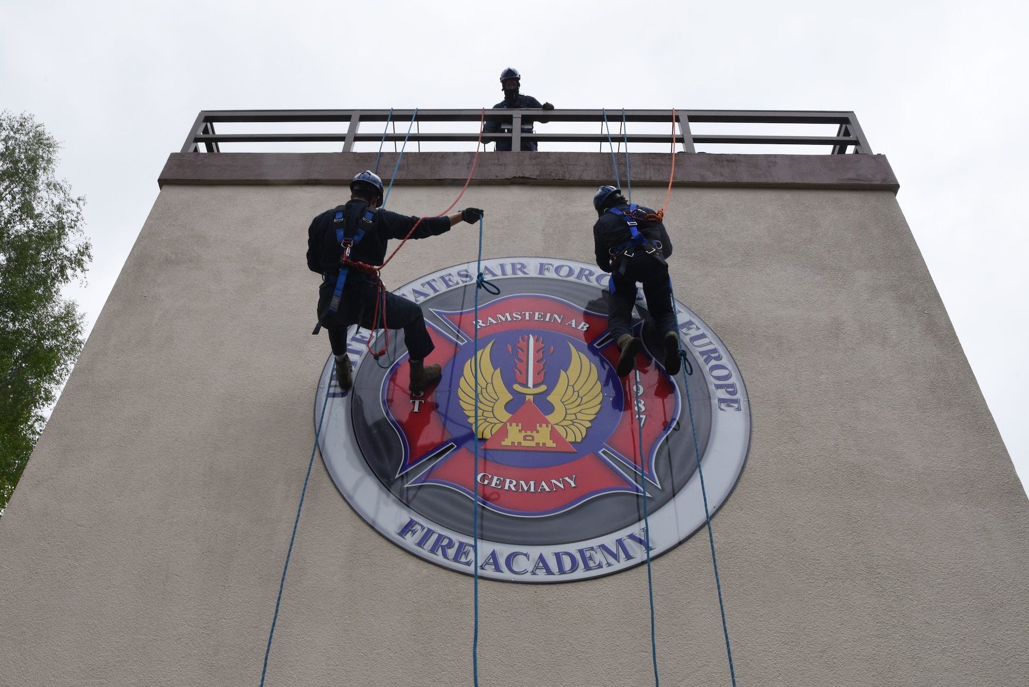 U.S. Air Force Airmen assigned to 86th Civil Engineer Squadron fire department rappel a structure during a rescue certification course.