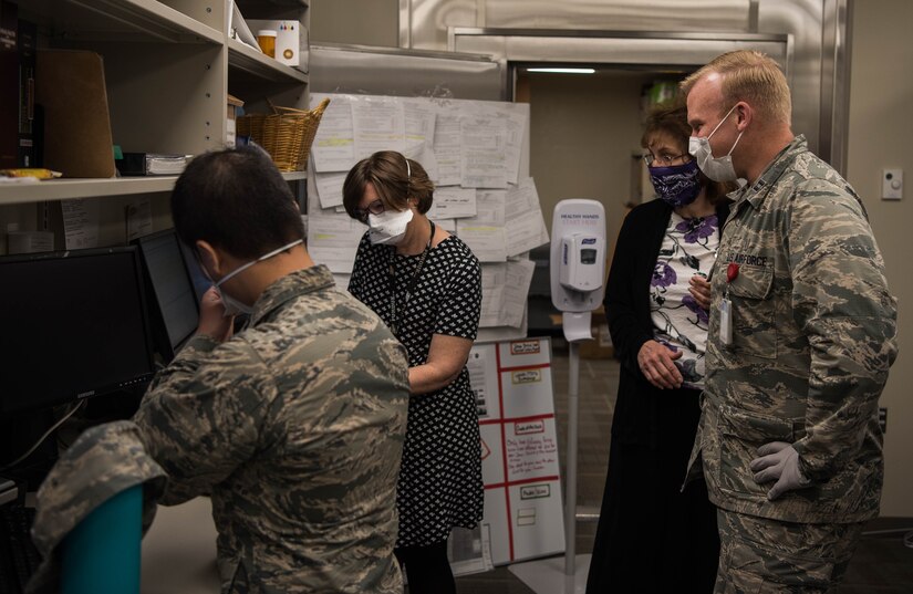 Members of the Satellite Pharmacy gather around a monitor at Joint Base Langley-Eustis, Virginia, April 28, 2020. The first week of servicing retirees on Mondays and Tuesdays, the pharmacy dispensed 3,000 prescriptions to 1,800 patients in two days with zero dispensing errors. (U.S. Air Force photo by Airman 1st Class Marcus M. Bullock)