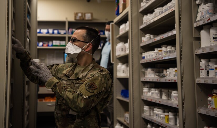 A U.S. Air Force Airman restocks the shelves with prescriptions at Joint Base Langley-Eustis, Virginia, April 28, 2020. Since initiating drive-thru procedures following the COVID-19 pandemic, the Satellite Pharmacy has seen patient traffic increase to approximately 4,800 prescriptions per week or 500 patients per day. (U.S. Air Force photo by Airman 1st Class Marcus M. Bullock)