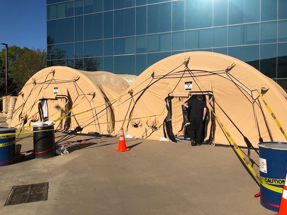 Military tents outside a hospital.