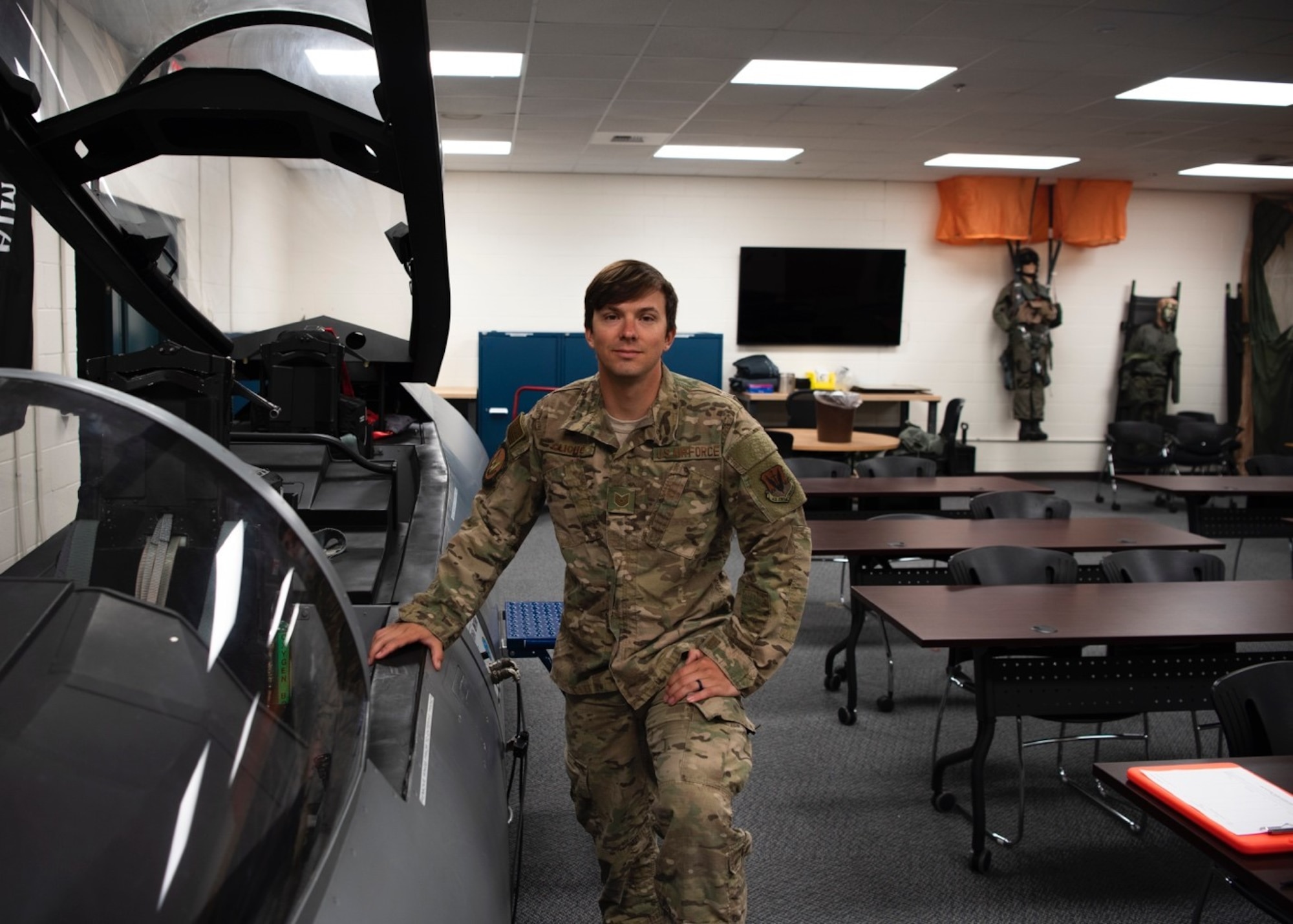 Tech. Sgt. Nicholas Cliché, 366th Operations Support Squadron air crew flight equipment lead trainer, posing with an F-15E evasion simulator, April 28, 2020, at Mountain Home Air Force Base, Idaho. As a Flight Equipment Trainer, Sgt. Cliché is accustomed to being ready for extreme situations. (U.S. Air Force photo by Airman 1st Class Gary Hilton)