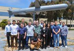 Members of the Tactical Tomahawk Weapon Control System hardware engineering group at NSWC PHD, circa 2018, including: Thomas Emmerich, Tomahawk product hardware lead (center in green jacket); and Mark Monaco, Tomahawk hardware design agent (left of Emmerich in light blue shirt).
