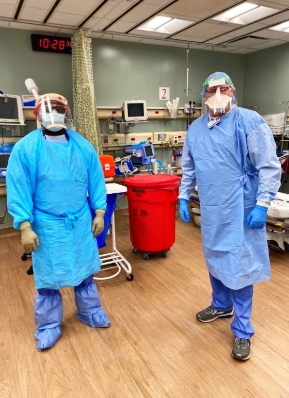 ELMHURST, Ill – U.S. Navy Lt. Cmdr. Ikeakaghichi Akanu (left), 4th Medical Battalion, Marine Corps Forces Reserve, and civilian medical provider pose for a photo at Elmhurst Medical Center in Elmhurst, Ill., April 11, 2020. The battalion, part of the Department of Defense COVID-19 response, coordinates closely with state, local, and public health authorities to ensure the well-being of their personnel and the local population.  U.S. Northern Command, through U.S. Army North, is providing military support to the Federal Emergency Management Agency to help communities in need. (Courtesy photo)