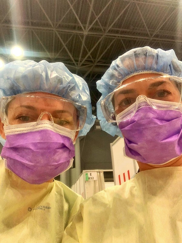 NEW YORK – Lt. Cmdr. Brittany Mertz (left), and Lt. Kelly Mitzen (right), both physician assistants currently with Expeditionary Medical Facility Bethesda from 4th Medical Battalion, Marine Corps Forces Reserve, take a photo at Javits New York Medical Station in N.Y., April 12, 2020.  The battalion, part of the Department of Defense COVID-19 response, coordinates closely with state, local, and public health authorities to ensure the well-being of their personnel and the local population. U.S. Northern Command, through U.S. Army North, is providing military support to the Federal Emergency Management Agency to help communities in need. (Courtesy photo)