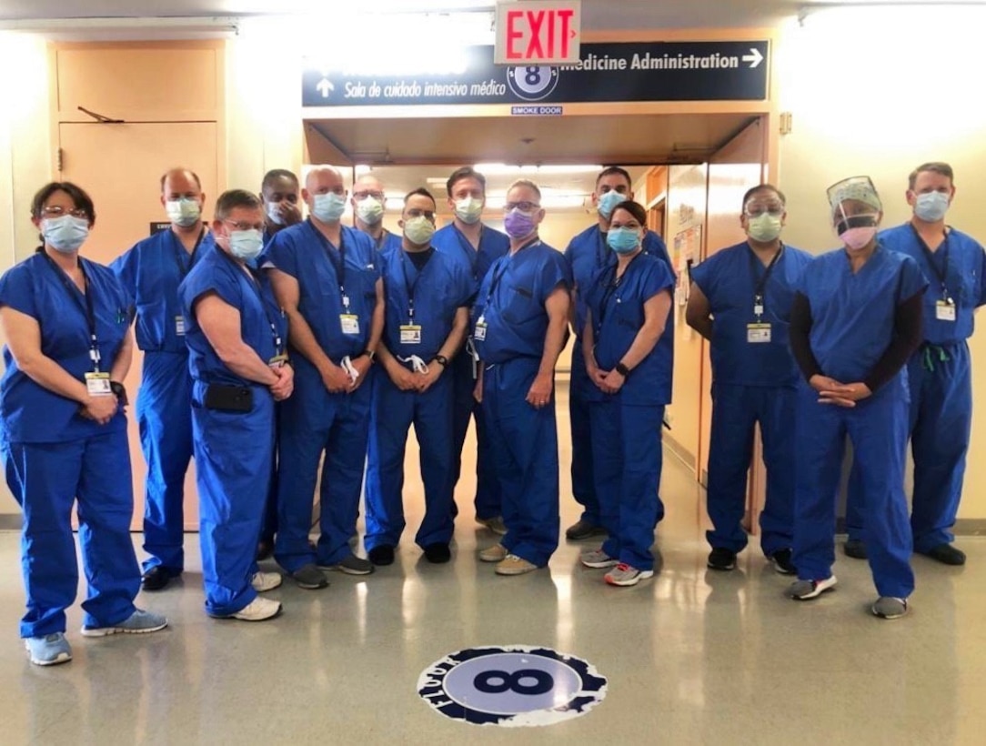 BROOKLYN, N.Y. – Woodhull Team-A Company, 4th Medical Battalion, Marine Corps Forces Reserve, pose for a photo at Woodhull Medical Center in Brooklyn, N.Y., April 18, 2020. Team members left to right: Capt. Julie Barr; Capt. Steven Posnick; Capt. Joseph Costabile; Cmdr. Tedman Vance; Lt. Cmdr. Michael Hall; Cmdr. Richard Heywood; Capt. Robert Gherman; Lt. Cmdr. Scott Farmer; Capt. Michael Sebesta; Cmdr. Eric Farabaugh; Cmdr. Melinda Kendrick; Cmdr. Juan Sanabria; Unknown civilian; 4th Medical Battalion Chief of Professional Services Capt. Michael Barker. The team, part of the Department of Defense COVID-19 response, coordinates closely with state, local, and public health authorities to ensure the well-being of their personnel and the local population. U.S. Northern Command, through U.S. Army North, is providing military support to the Federal Emergency Management Agency to help communities in need. (Courtesy photo)