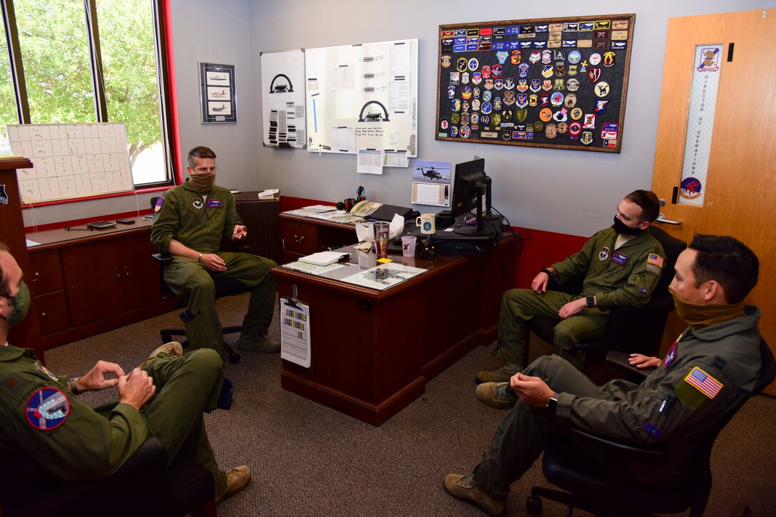Lt. Col. Brian Tripp, 434th Flying Training Squadron director of operations, gathers with Capt. Joshua White, 434th FTS X flight commander and instructor pilot, and others for a meeting, April 23, 2020 at Laughlin Air Force Base, Texas. “Just like much of the world we feel like we are all in this together, and we are prepared to do anything we can to help the instructor pilots and students,” White said. “As a flight commander my main concern right now is to take care of my instructors and students. If they feel like we don’t care or if they are worried for their safety they will not be able to meet their full potential every day. We need them focused on safety and training.” (U.S. Air Force photo by Senior Airman Anne McCready)