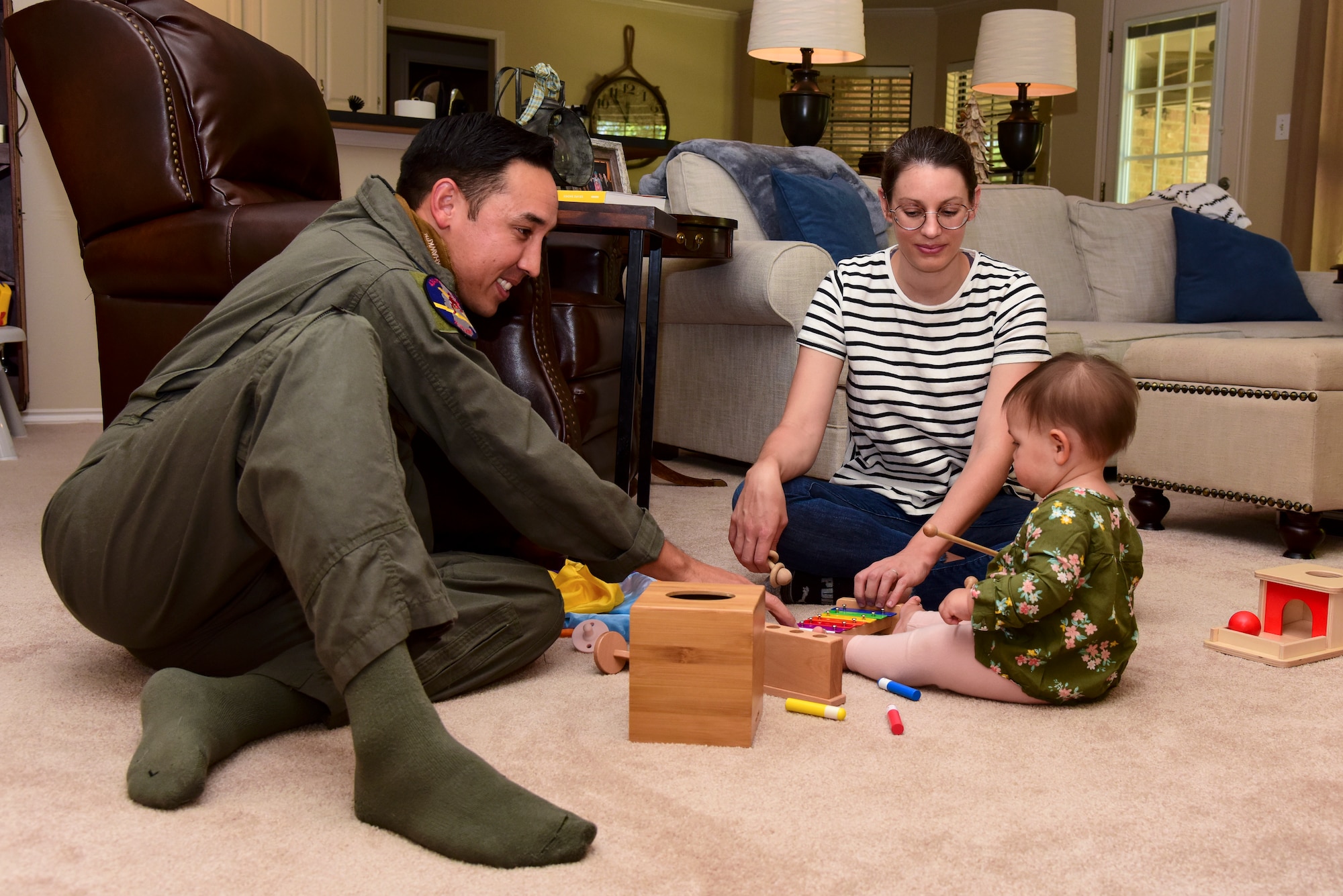 Capt. Joshua White, 434th Flying Training Squadron X flight commander and instructor pilot, Candice White, his wife and Dylan their daughter, spend some quality time together before work, April 23, 2020 in Del Rio, Texas. During quarantine, they enjoy going on walks, playing in the living room and video chatting with family who lives farther away. “Spending time with my family has always been important to me and is even more important now,” White said. “This pandemic has made me more thankful for the small things in life and appreciative of the present.” (U.S. Air Force photo by Senior Airman Anne McCready)