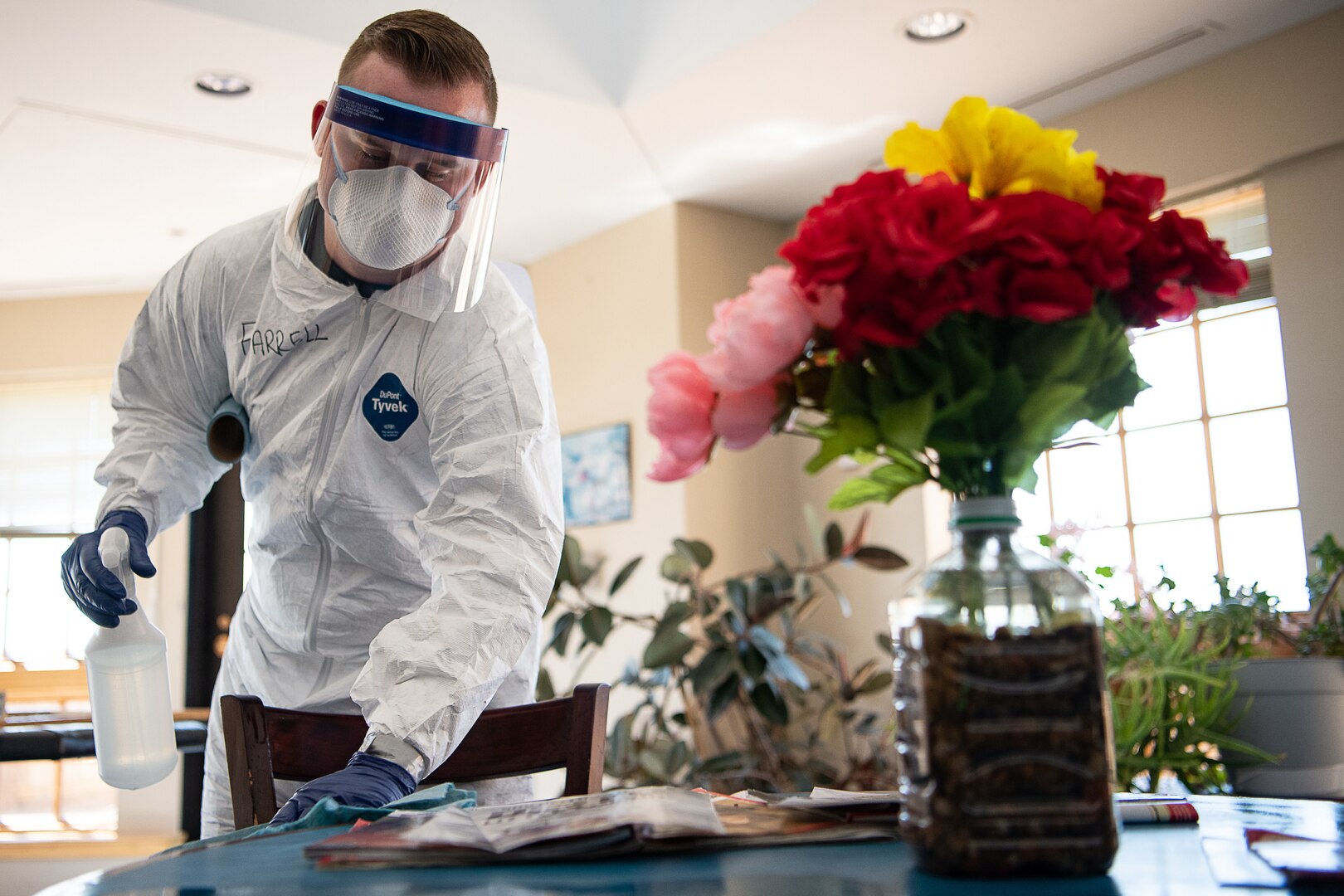A member of the Oklahoma Army National Guard wipes the tabletop of a common area in the Norman Veterans Center in Norman, Oklahoma, April 29, 2020. Guard members disinfected commonly touched surfaces and high traffic areas of the 275,000 square-foot facility.